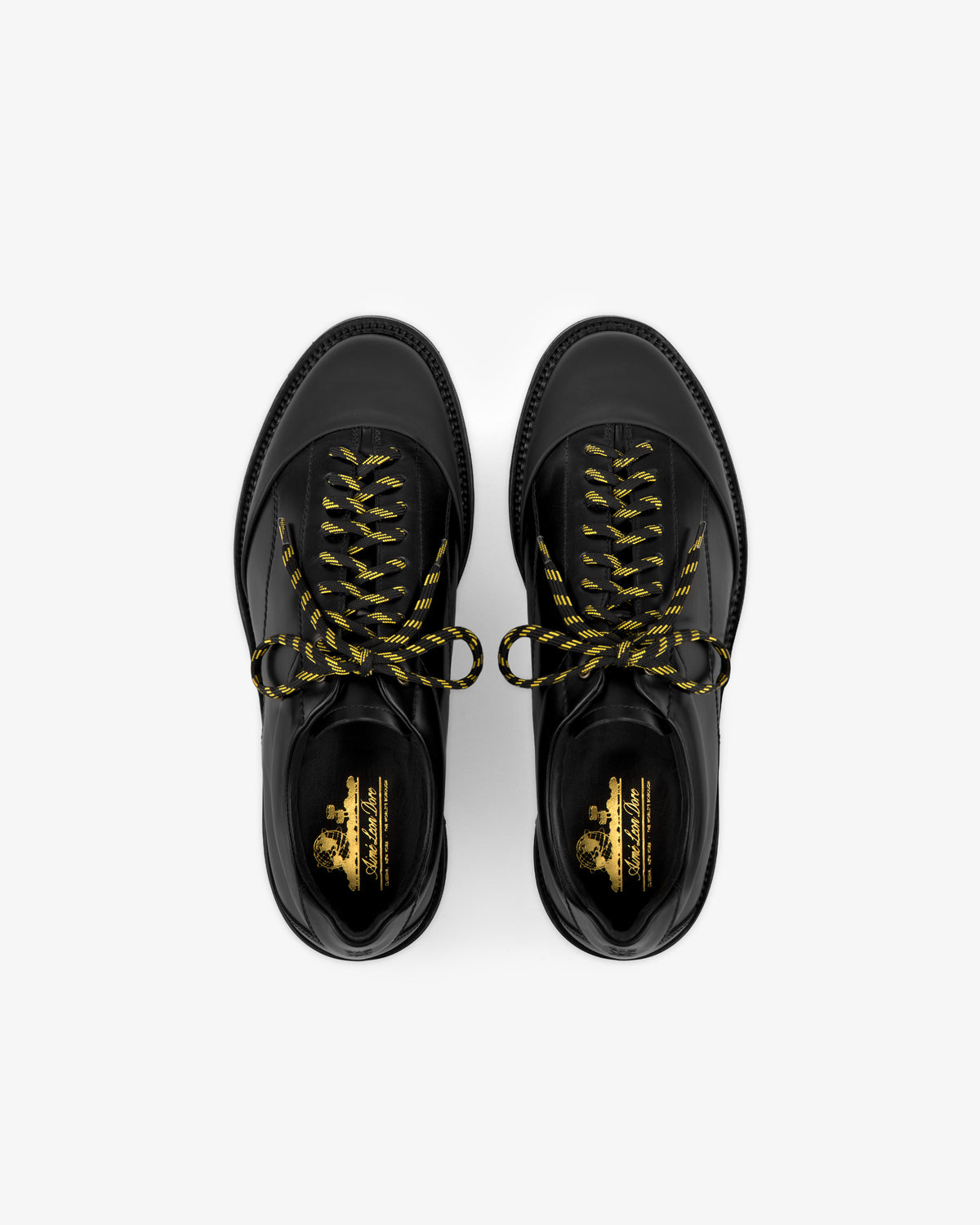 Leather Derby Hiker shoes with yellow and black striped laces, top view on a white background.