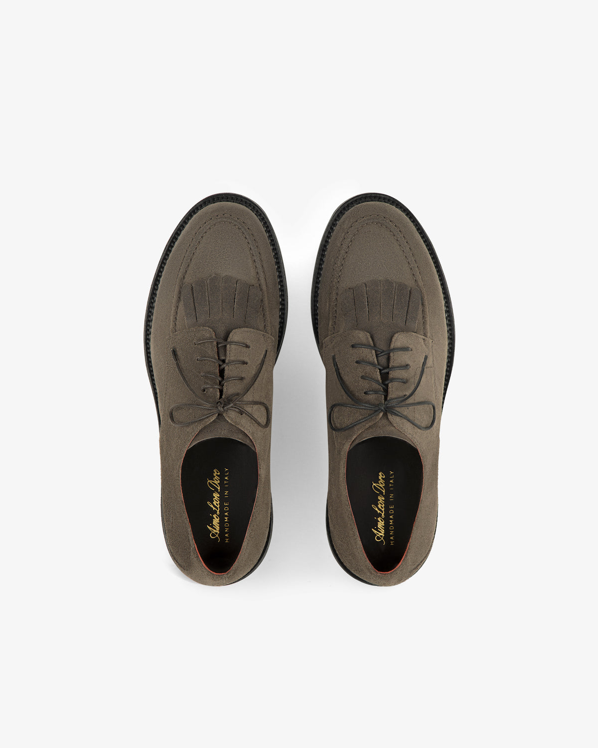 Suede Lug Sole Derby: brown suede lace-up shoes with brogue detailing and fringe on a white background.
