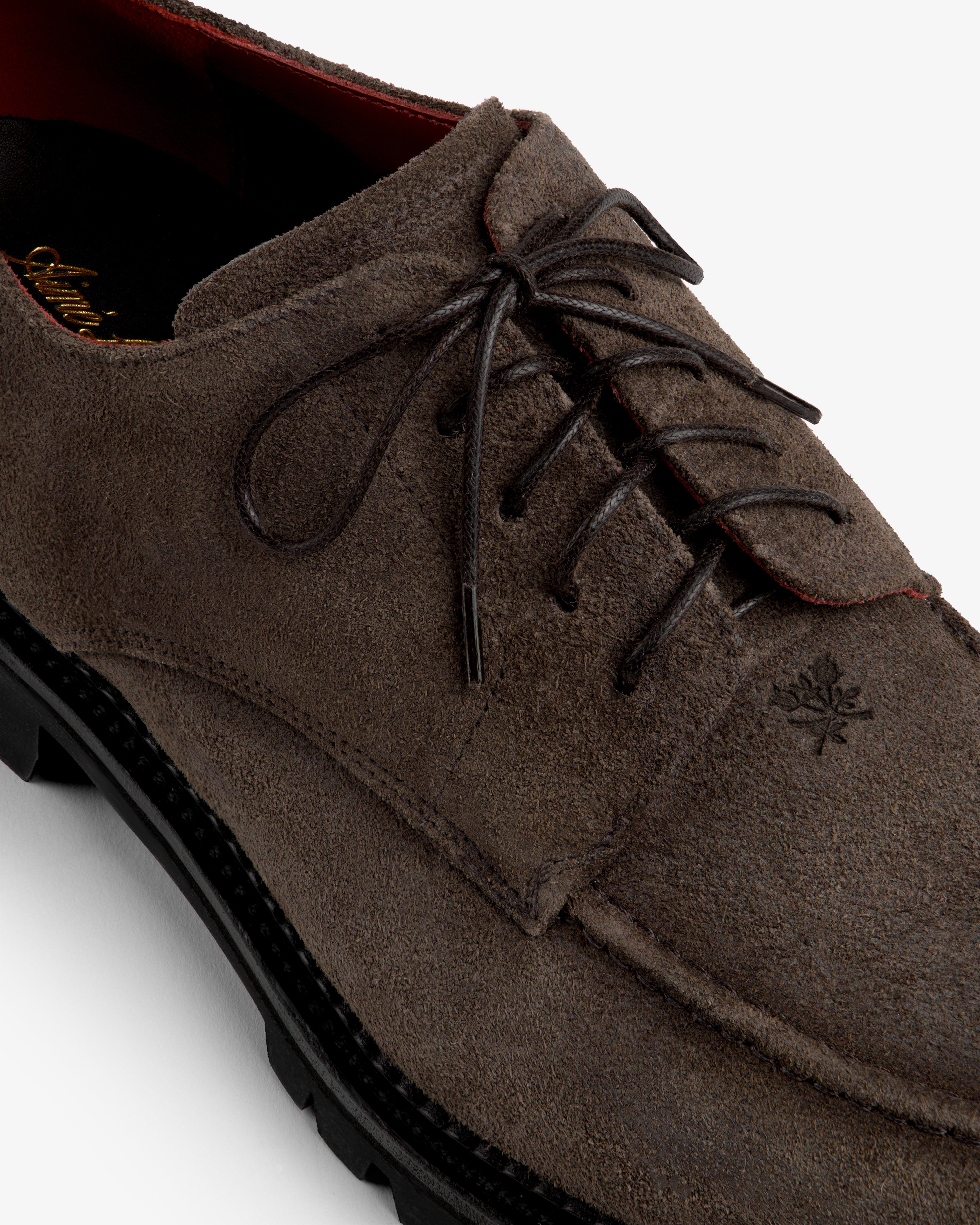 Suede Lug Sole Derby in dark brown suede with a thick black lug sole and dark laces.