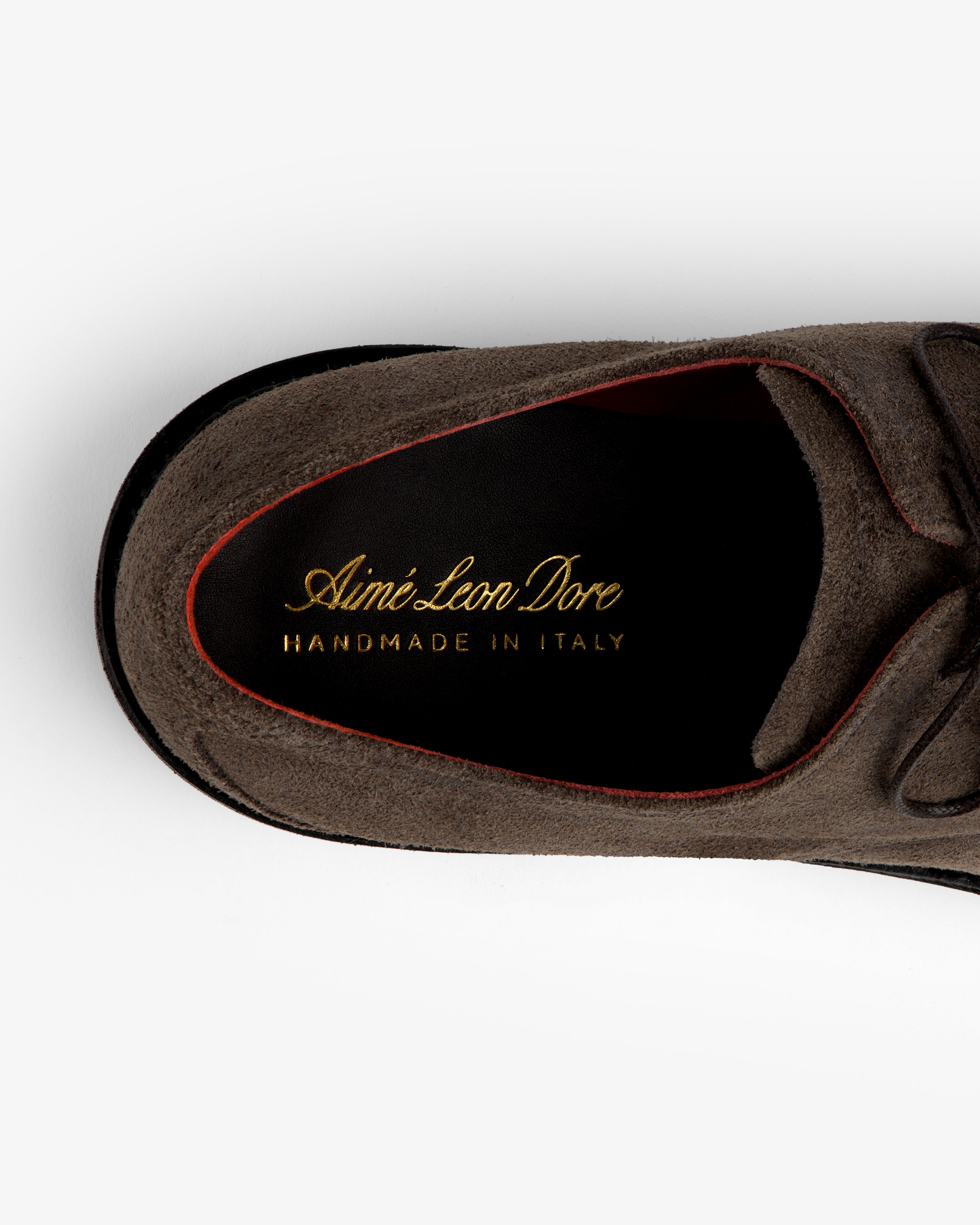 Top view of a brown Suede Lug Sole Derby showing the brand logo and Handmade in Italy text on the black insole.