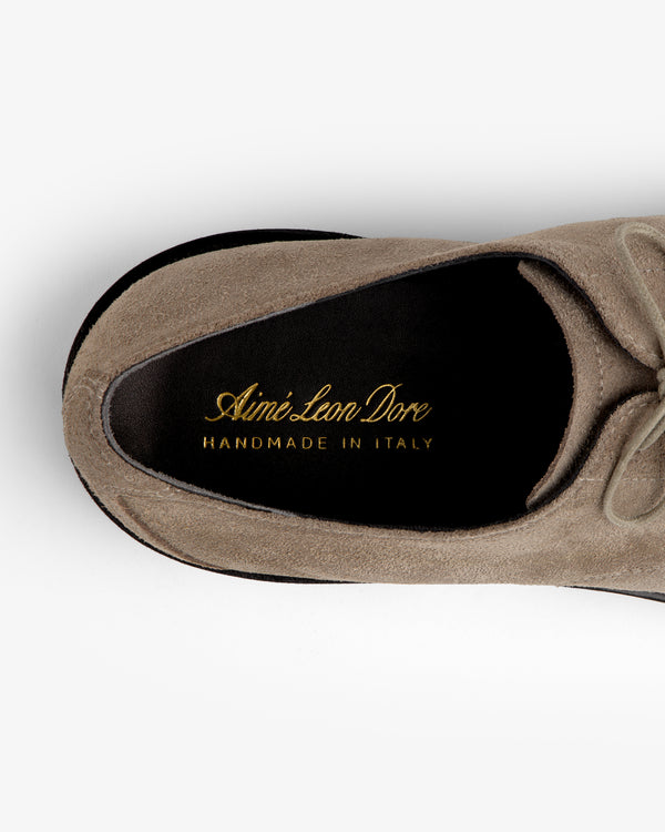 Top-down view of a taupe Suede Lug Sole Derby, showing the interior heel with gold embossed branding.