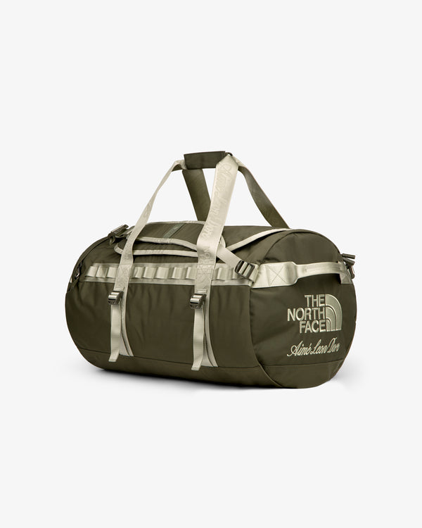 Olive green ALD / The North Face Base Camp Duffel with beige straps and logo on a plain white background.