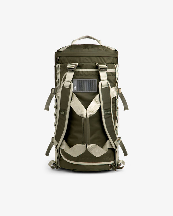 ALD / The North Face Base Camp Duffel in olive green and beige with padded straps and top handle.