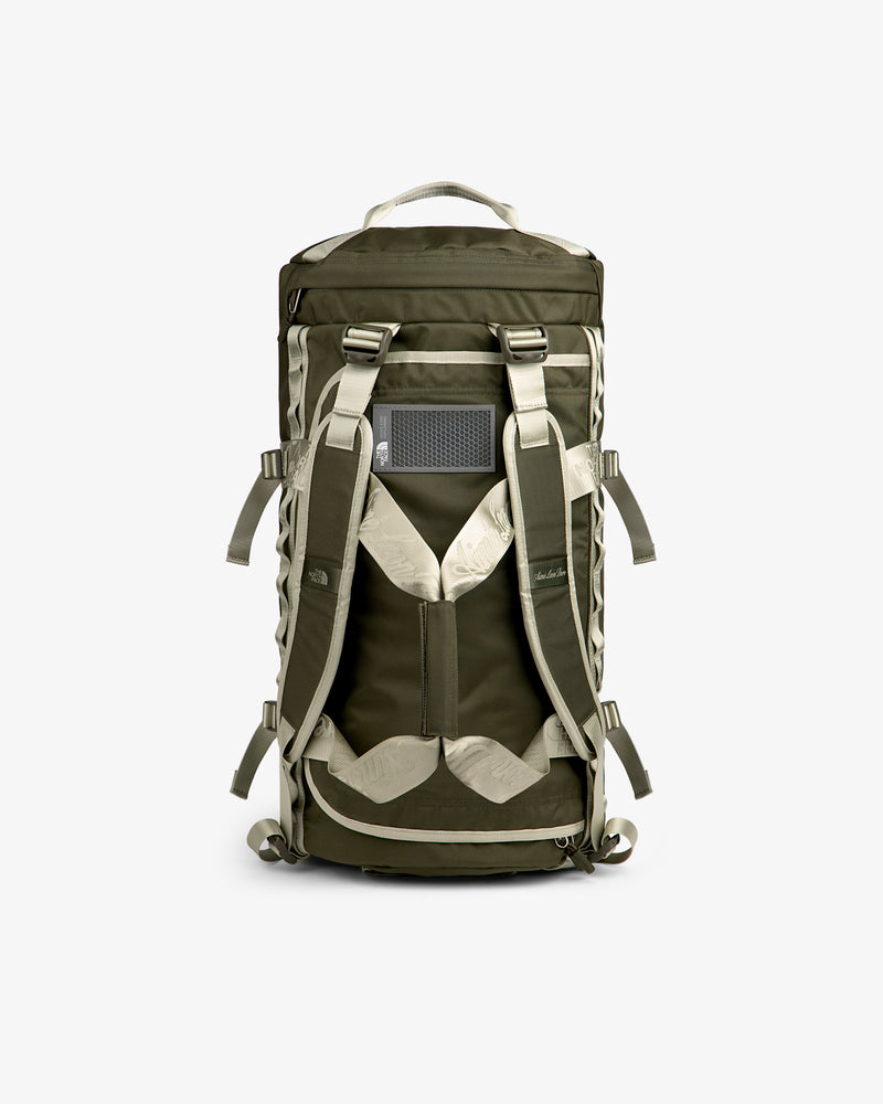 ALD / The North Face Base Camp Duffel in olive green and beige with padded straps and top handle.