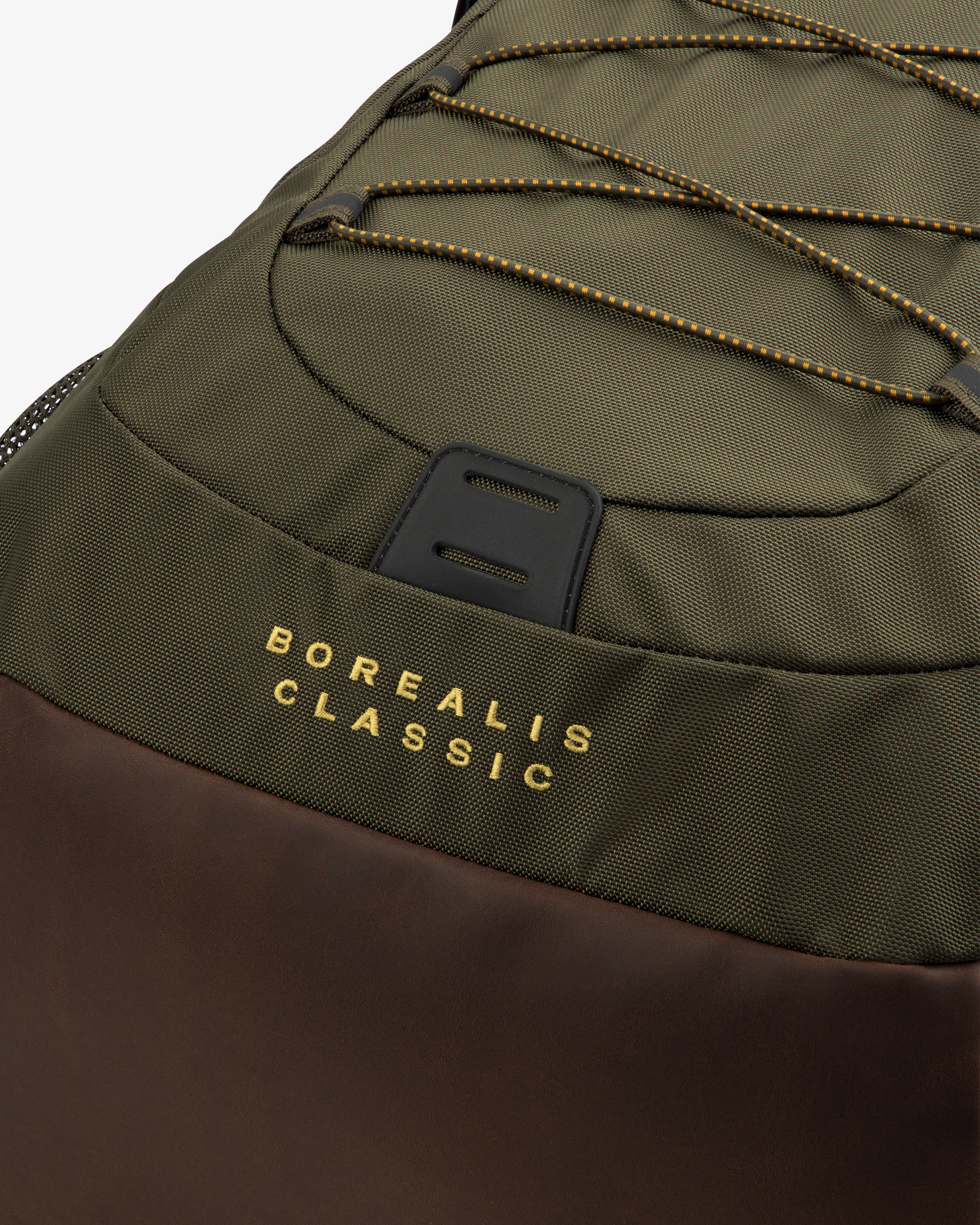 Close-up of olive-green ALD / The North Face Borealis Backpack with brown details and yellow-trimmed cords.