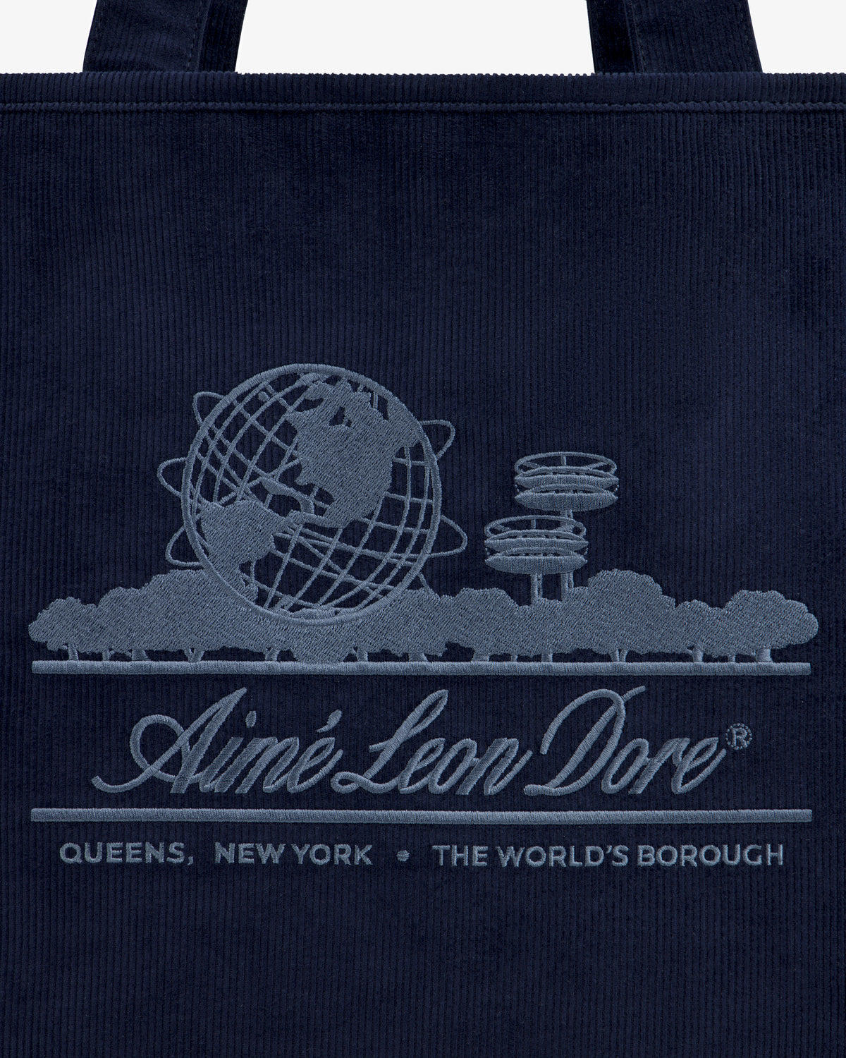 Large Corduroy Unisphere Tote Bag in dark navy with an embroidered Unisphere, brand name, and QUEENS, NEW YORK.