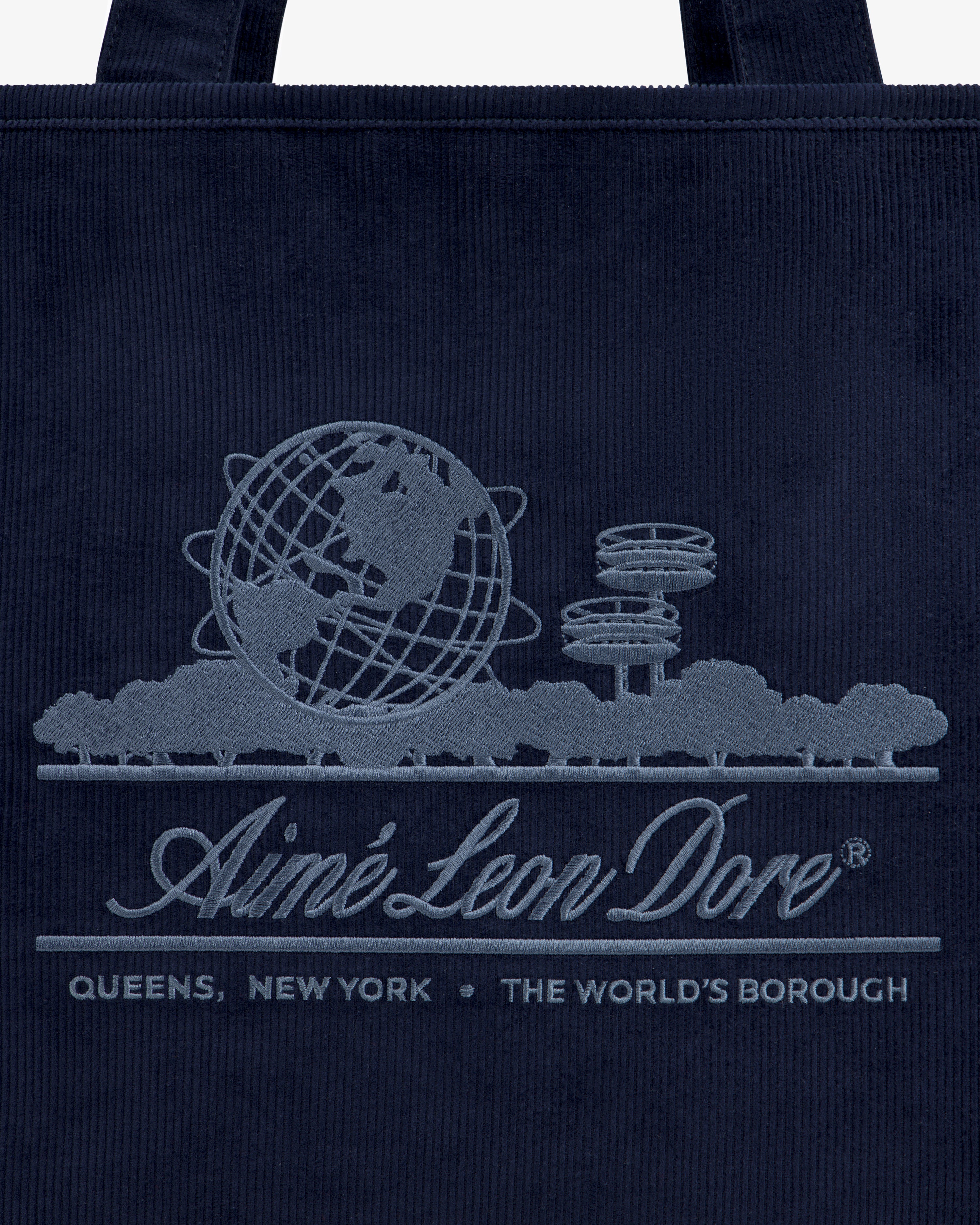 Large Corduroy Unisphere Tote Bag in dark navy with an embroidered Unisphere, brand name, and QUEENS, NEW YORK.