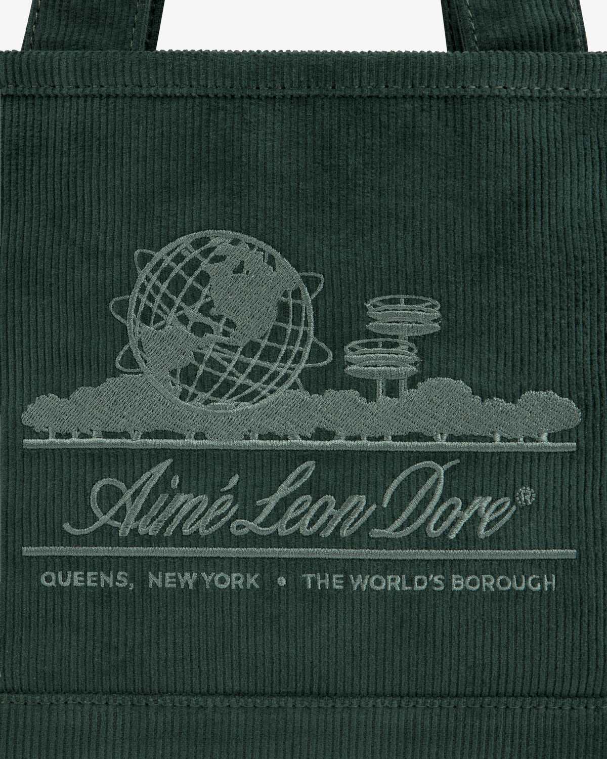 Mini Corduroy Unisphere Tote Bag in dark green with an embroidered globe and cityscape logo reading Aimé Leon Dore.