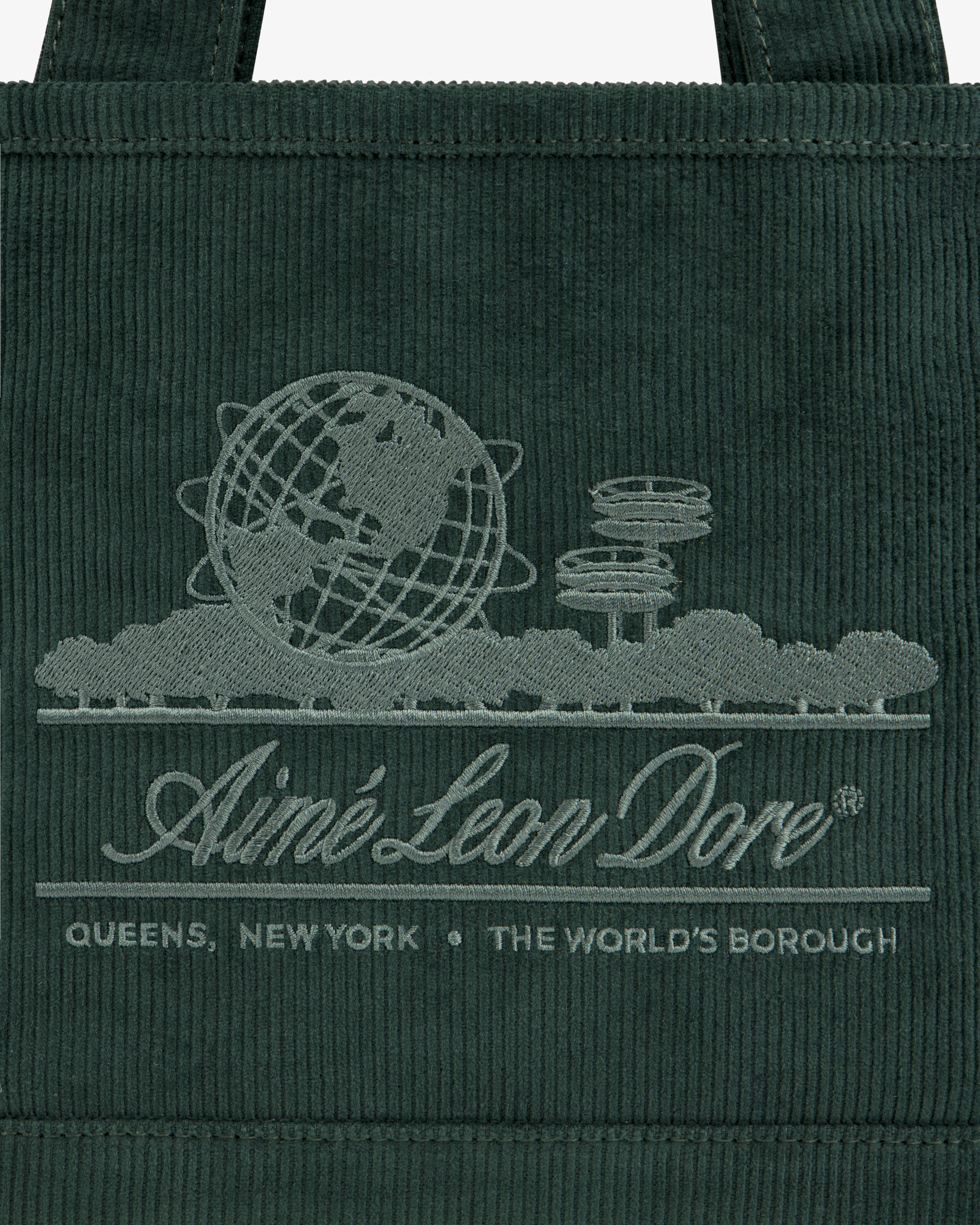 Mini Corduroy Unisphere Tote Bag in dark green with an embroidered globe and cityscape logo reading Aimé Leon Dore.