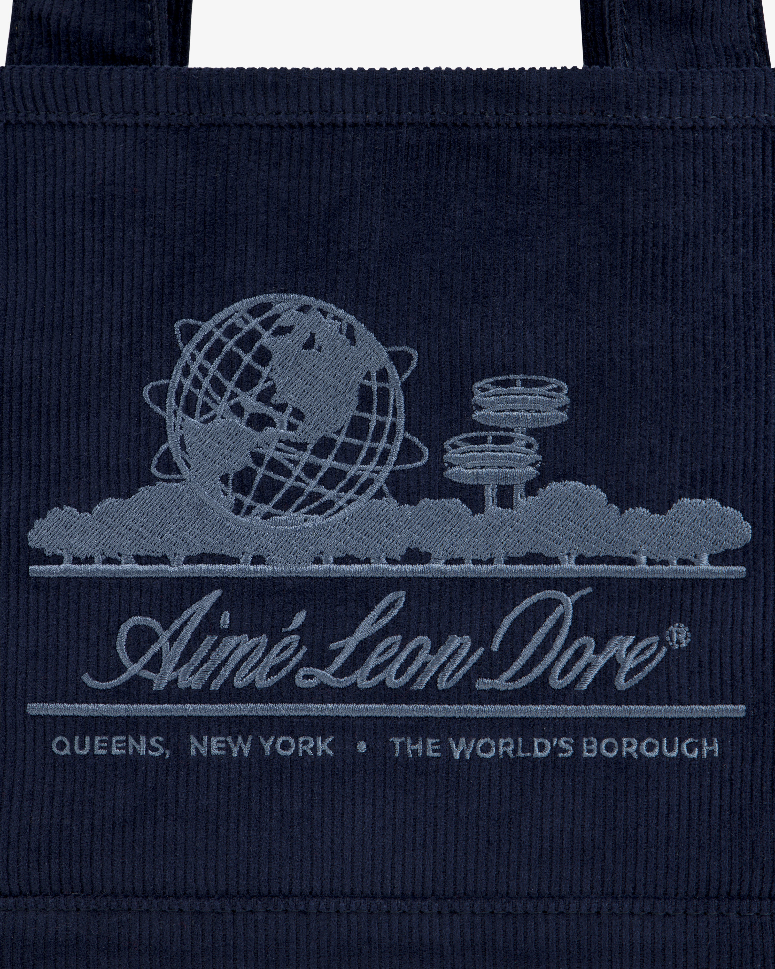Mini Corduroy Unisphere Tote Bag in dark blue, featuring an embroidered Unisphere, trees, and Aimé Leon Dore branding.