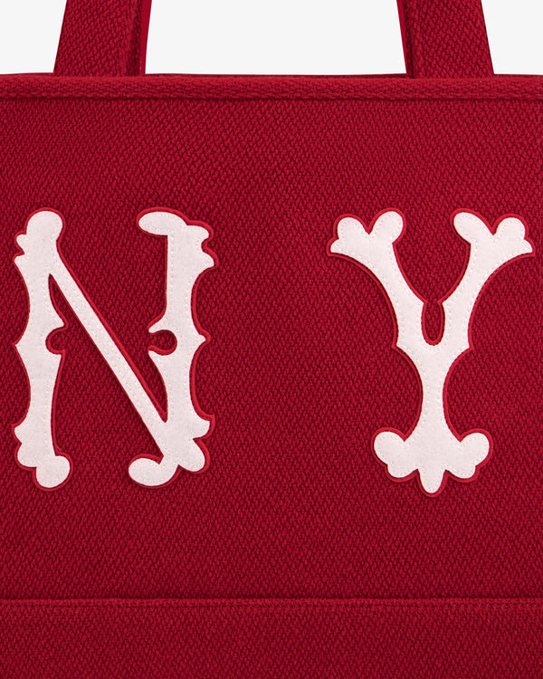 Close-up of a red NY Highlanders Wool Tote Bag featuring large white embroidered N Y lettering.
