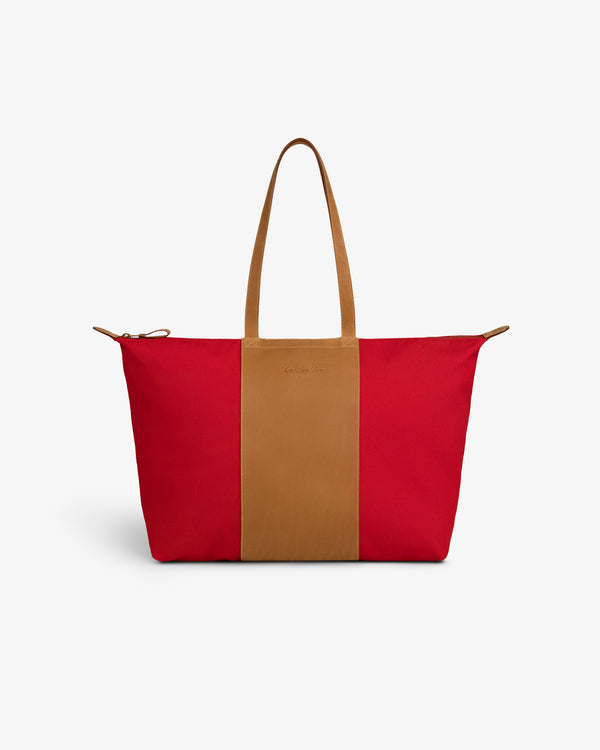 Leather Canvas Zip Tote in red with tan handles and center stripe, shown on a plain white background.