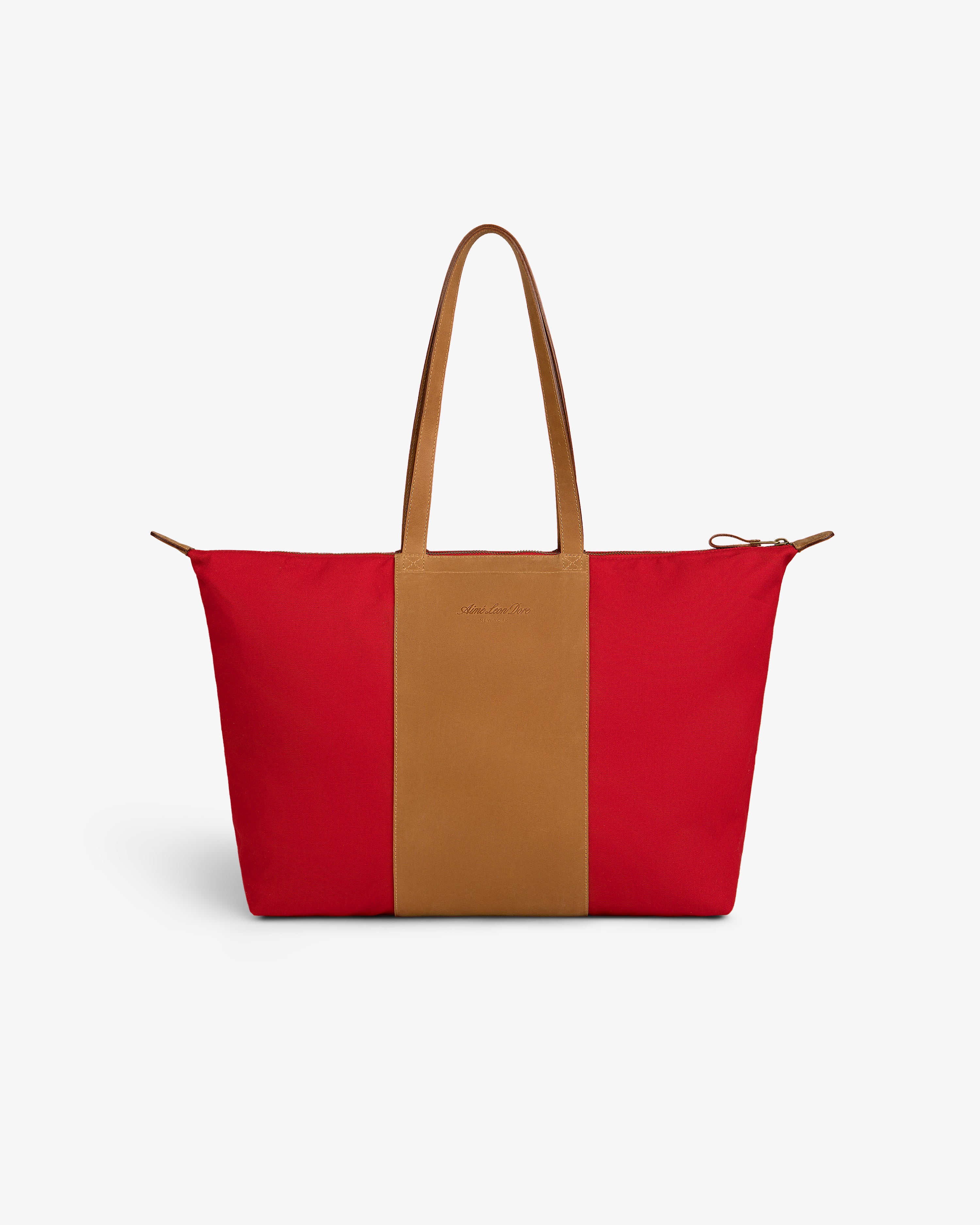 Leather Canvas Zip Tote with tan handles and a tan stripe, shown on a plain white background.