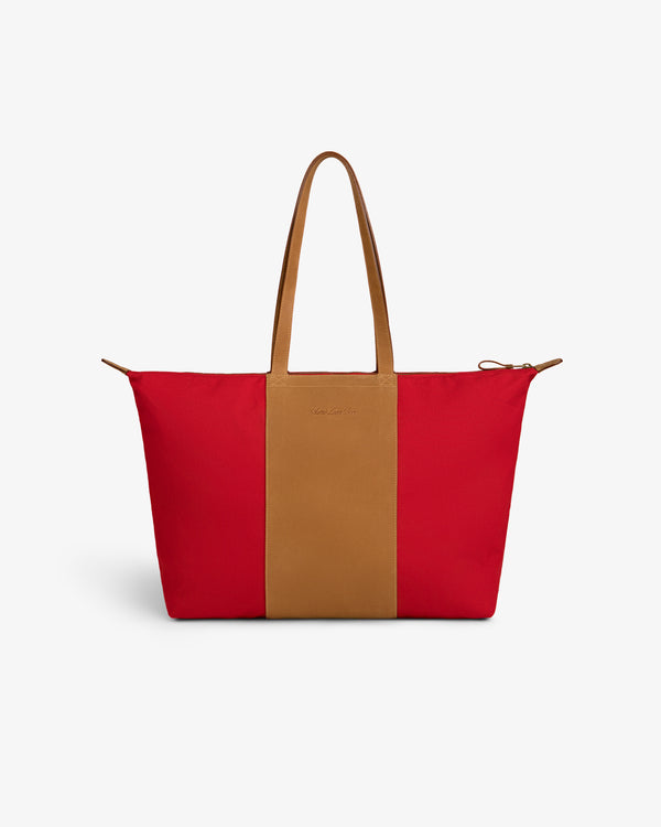 Leather Canvas Zip Tote with tan handles and a tan stripe, shown on a plain white background.