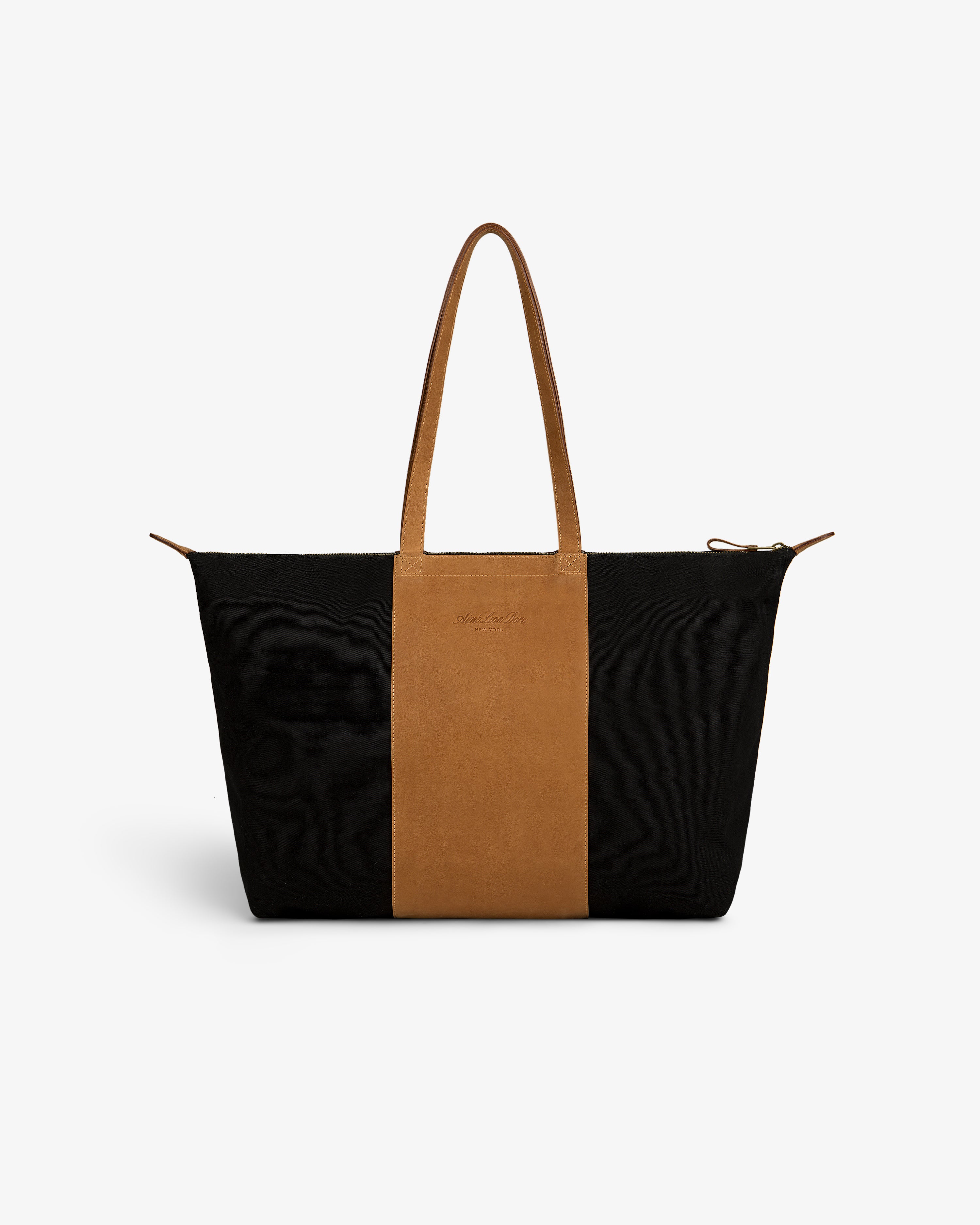 Leather Canvas Zip Tote in black and brown with two handles, displayed on a plain white background.