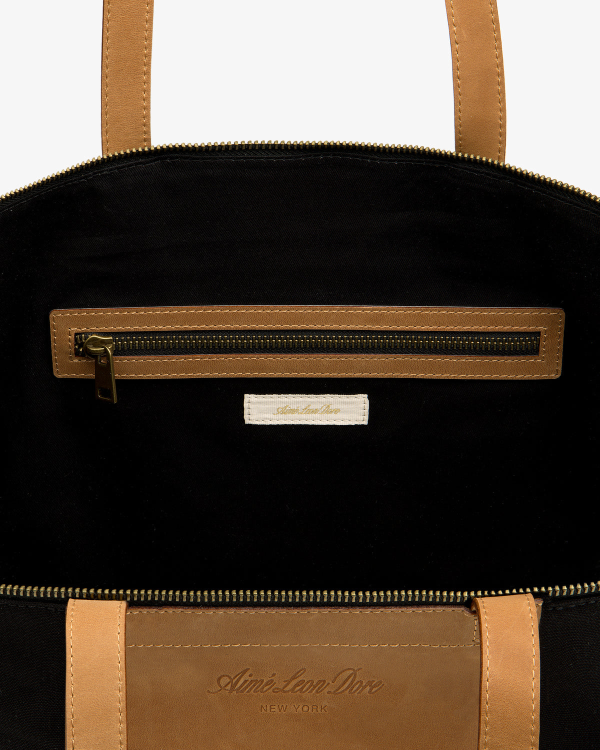 Leather Canvas Zip Tote: tan leather, black interior, zip pocket, Aimé Leon Dore New York label inside.