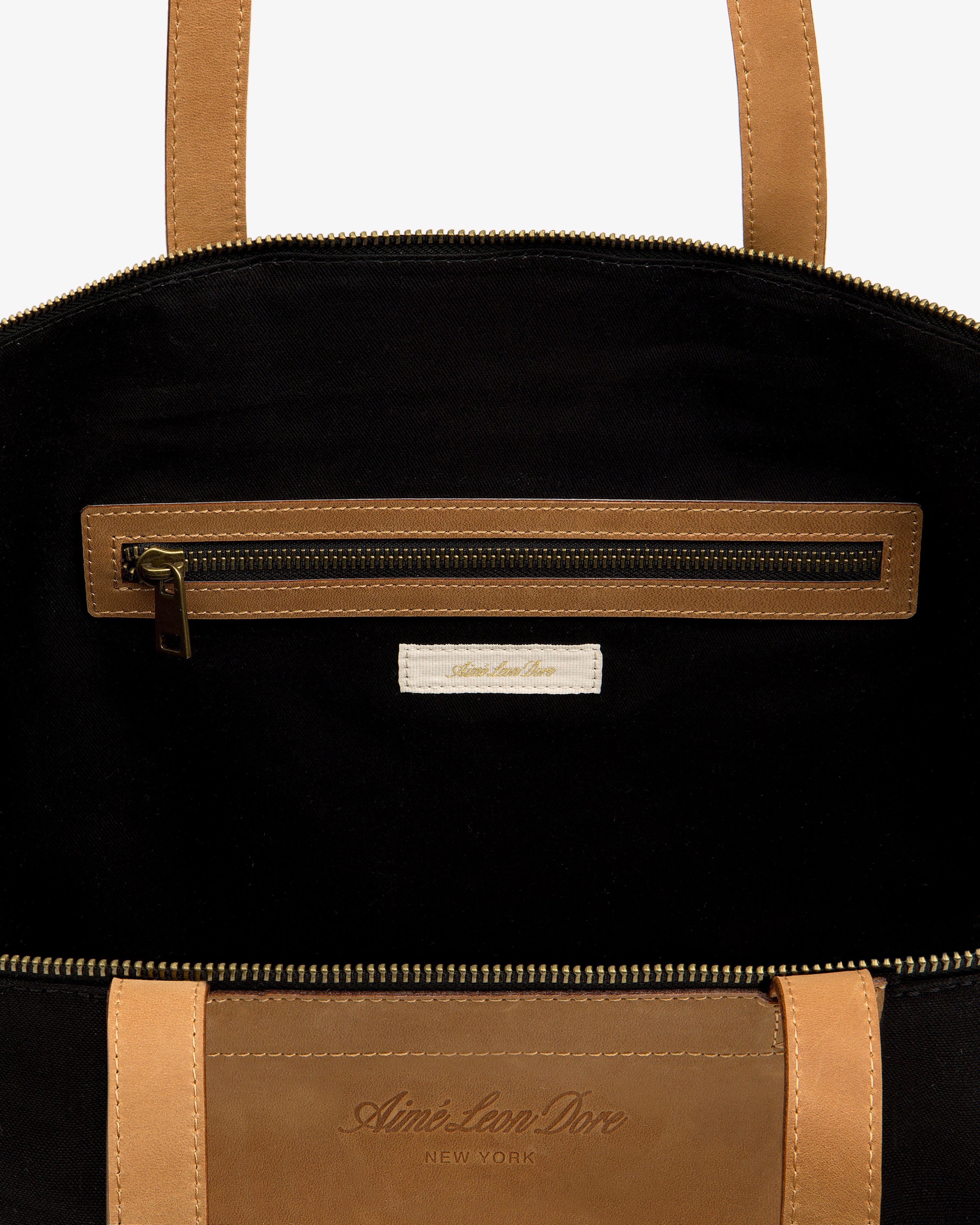 Leather Canvas Zip Tote: tan leather, black interior, zip pocket, Aimé Leon Dore New York label inside.