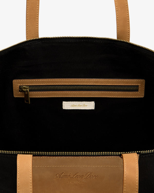 Leather Canvas Zip Tote: tan leather, black interior, zip pocket, Aimé Leon Dore New York label inside.