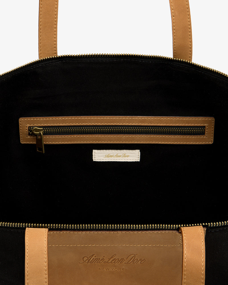 Leather Canvas Zip Tote: tan leather, black interior, zip pocket, Aimé Leon Dore New York label inside.