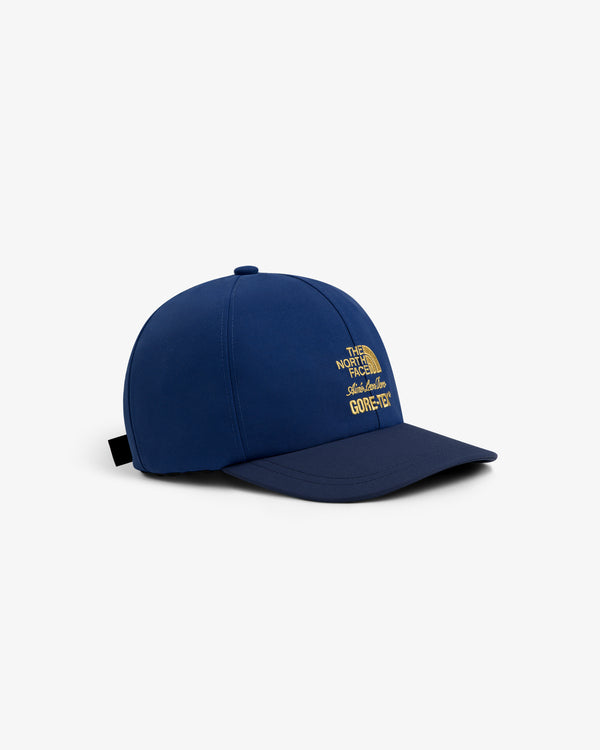 ALD / The North Face GORE-TEX Hat in blue with yellow embroidery, shown on a white background.
