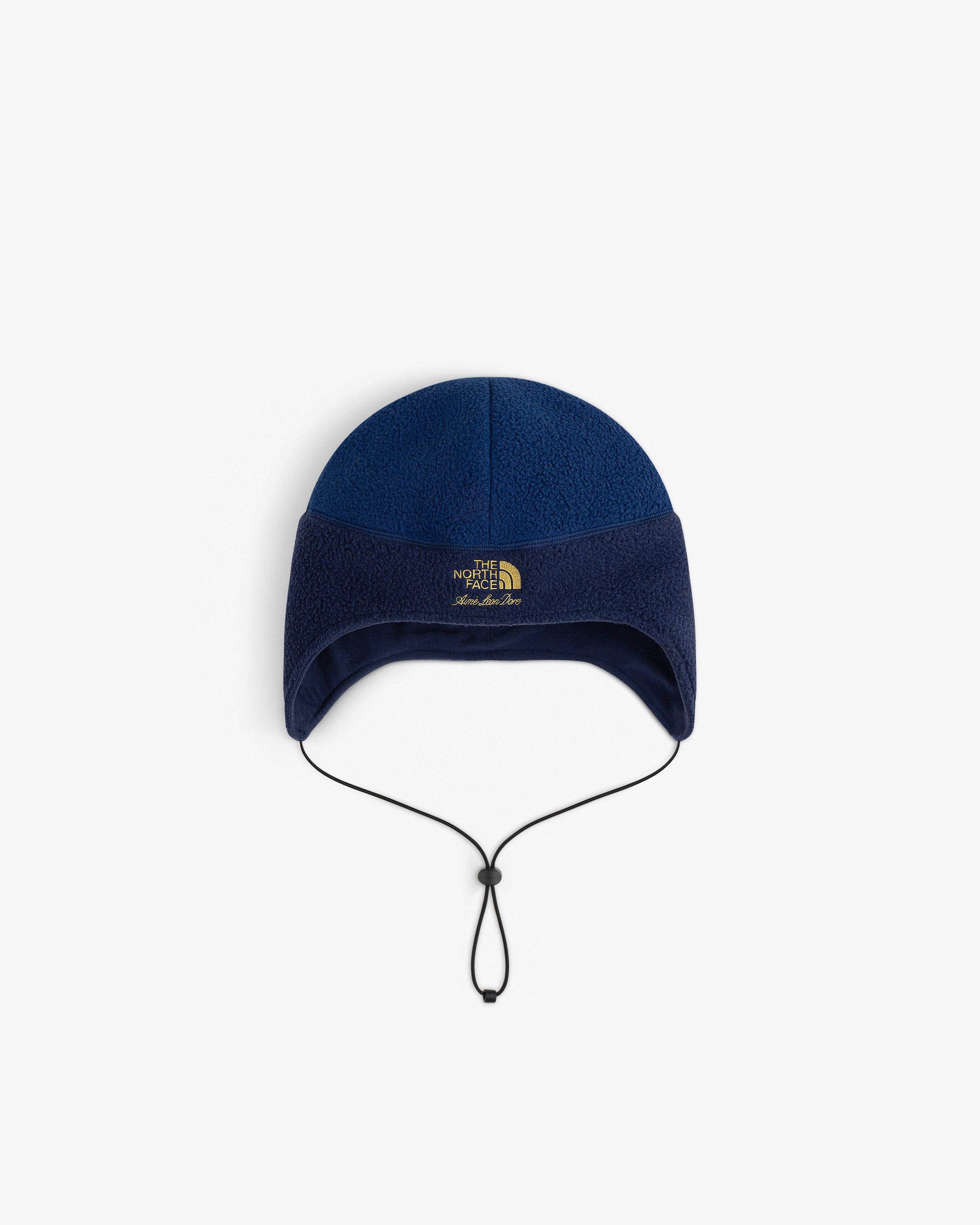 ALD / The North Face blue fleece earflap hat with drawstring, top view on white background.