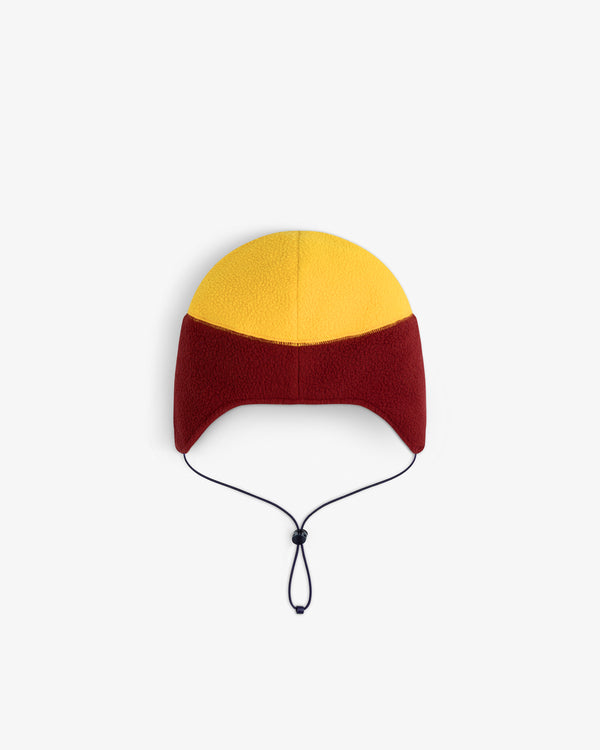 ALD/The North Face Fleece Earflap Hat in yellow and red with a black chin strap, shown on a white background.