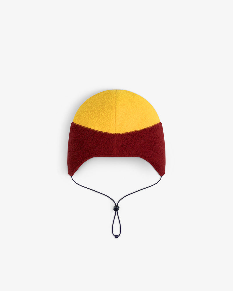 ALD/The North Face Fleece Earflap Hat in yellow and red with a black chin strap, shown on a white background.