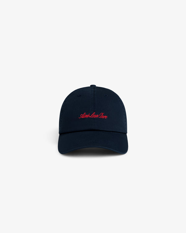 Washed Script Chino Hat in navy with Aime Leon Dore red cursive embroidery on front, shown on white background.