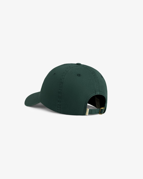 The Washed Script Chino Hat in dark green features an adjustable strap and metal buckle, shown from the back.