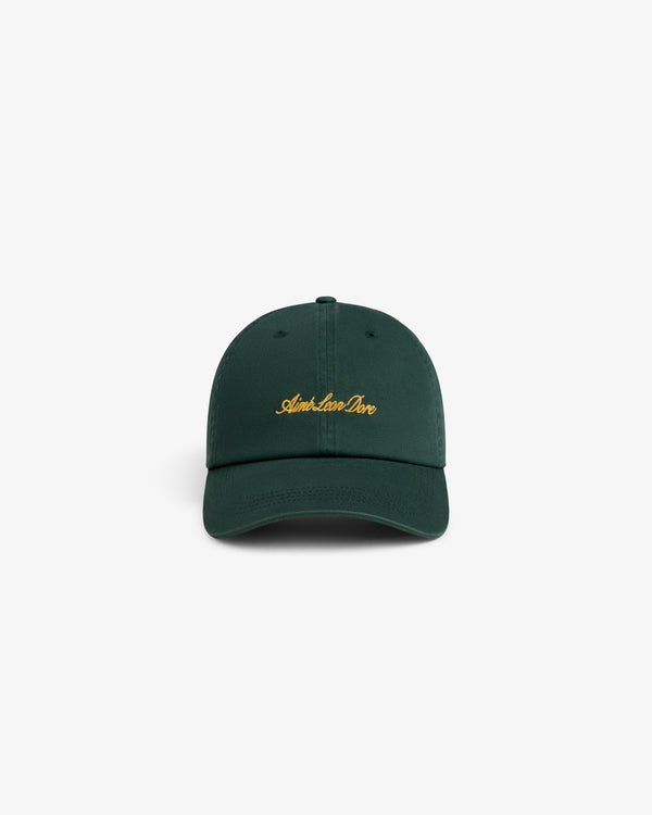 Washed Script Chino Hat in dark green with yellow Aimé Leon Dore text, displayed on a white background.
