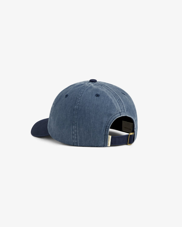 Back view of a Pigment Dyed Logo Hat in blue denim with adjustable strap and metal buckle.