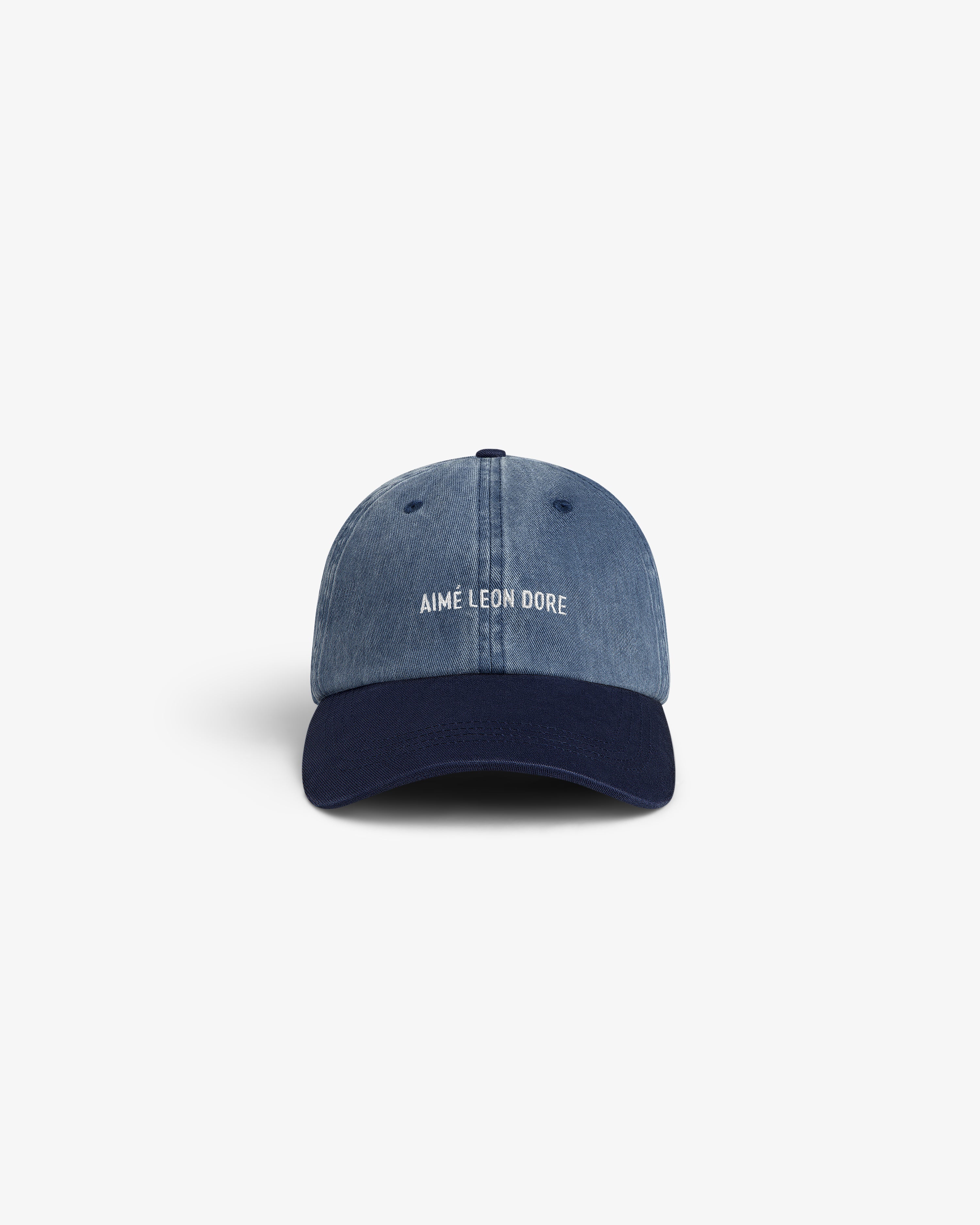 Pigment Dyed Logo Hat: Blue denim cap with navy brim, Aimé Leon Dore logo embroidered in white on front.