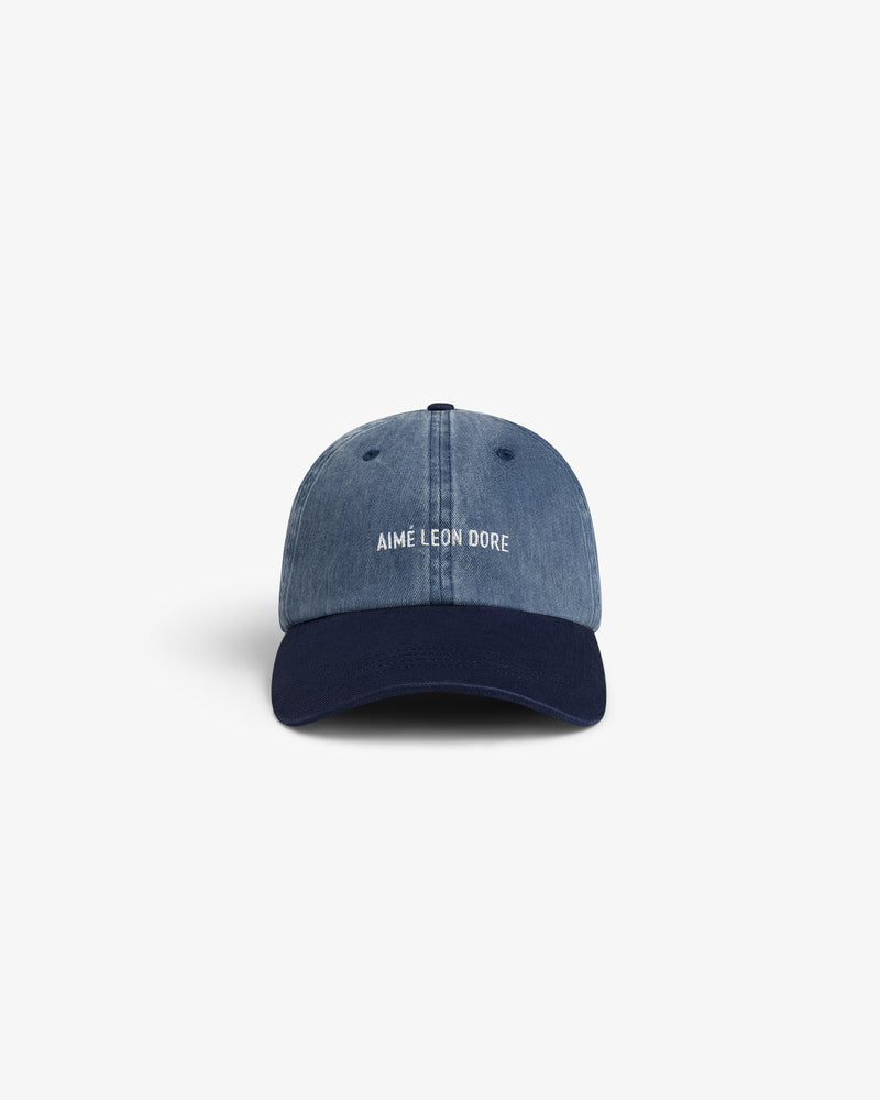 Pigment Dyed Logo Hat: Blue denim cap with navy brim, Aimé Leon Dore logo embroidered in white on front.
