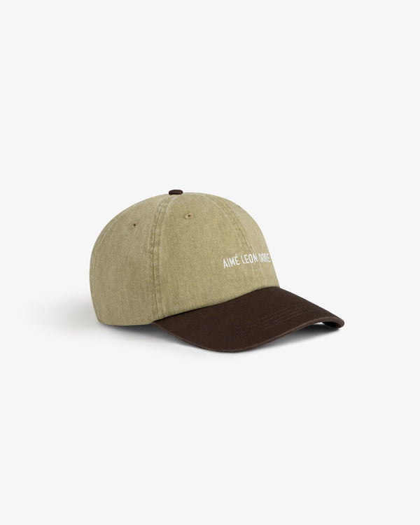 Pigment Dyed Logo Hat in olive with a dark brown brim and AIMÉ LEON DORE embroidered white on the front.