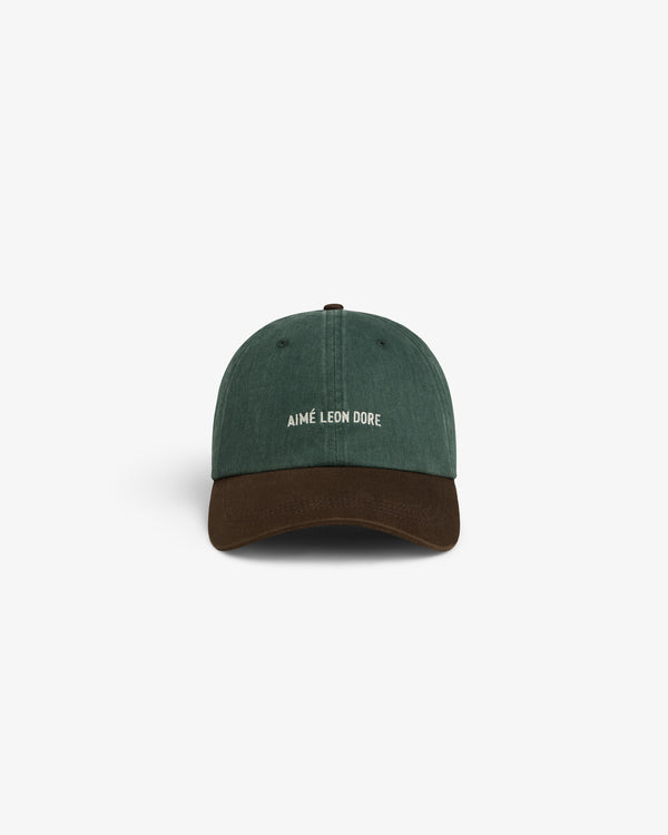 Green and brown Pigment Dyed Logo Hat with white AIMÉ LEON DORE front embroidery, shown on a white background.