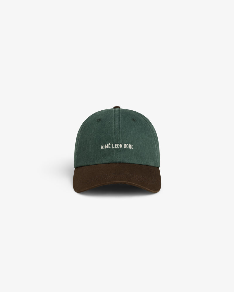 Green and brown Pigment Dyed Logo Hat with white AIMÉ LEON DORE front embroidery, shown on a white background.
