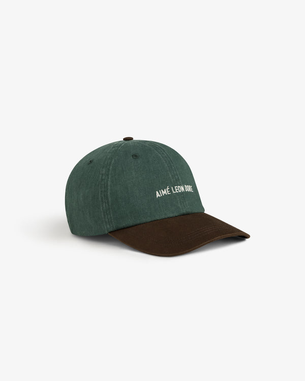 Pigment Dyed Logo Hat in green and brown with AIMÉ LEON DORE white embroidery, shown on a white background.