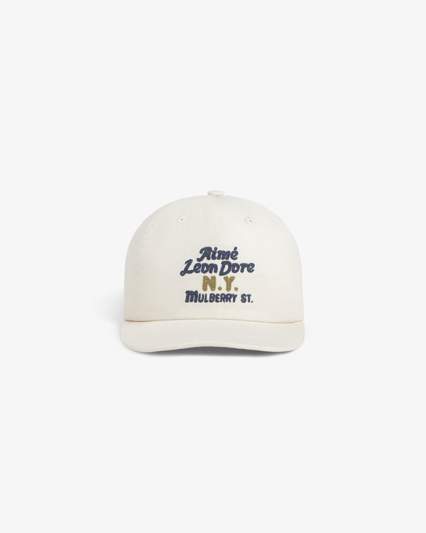 Cream Mulberry Chainstitch Hat with blue “Aimé Leon Dore N.Y. MULBERRY ST.” text on the front.