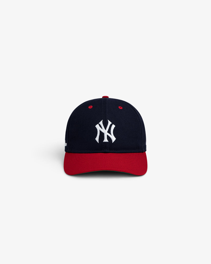 ALD / New Era Yankees Retro Fit Hat in navy with a red brim and white Yankees logo on the front.