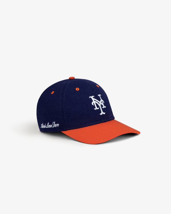 ALD / New Era Mets Retro Fit Hat, a navy blue baseball cap with an orange brim and a white embroidered Mets logo.
