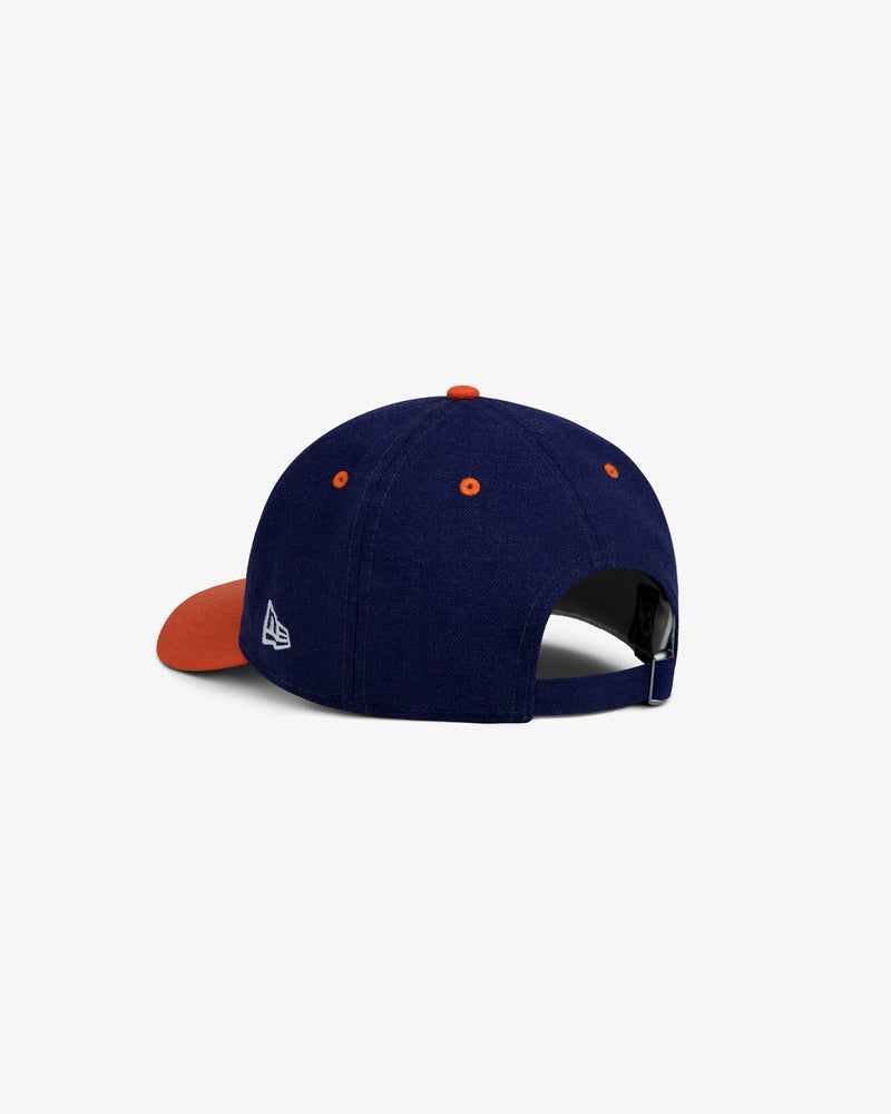 ALD / New Era Mets Retro Fit Hat: navy blue baseball cap with an orange brim, button, and eyelets with a white side logo.