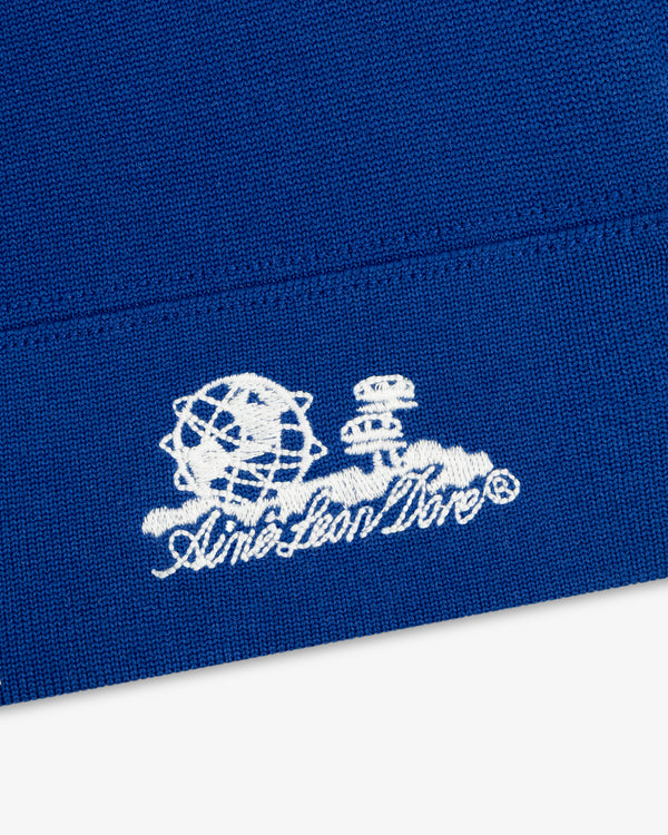 White Unisphere Skull Cap logo with globe and structures, embroidered on blue fabric.