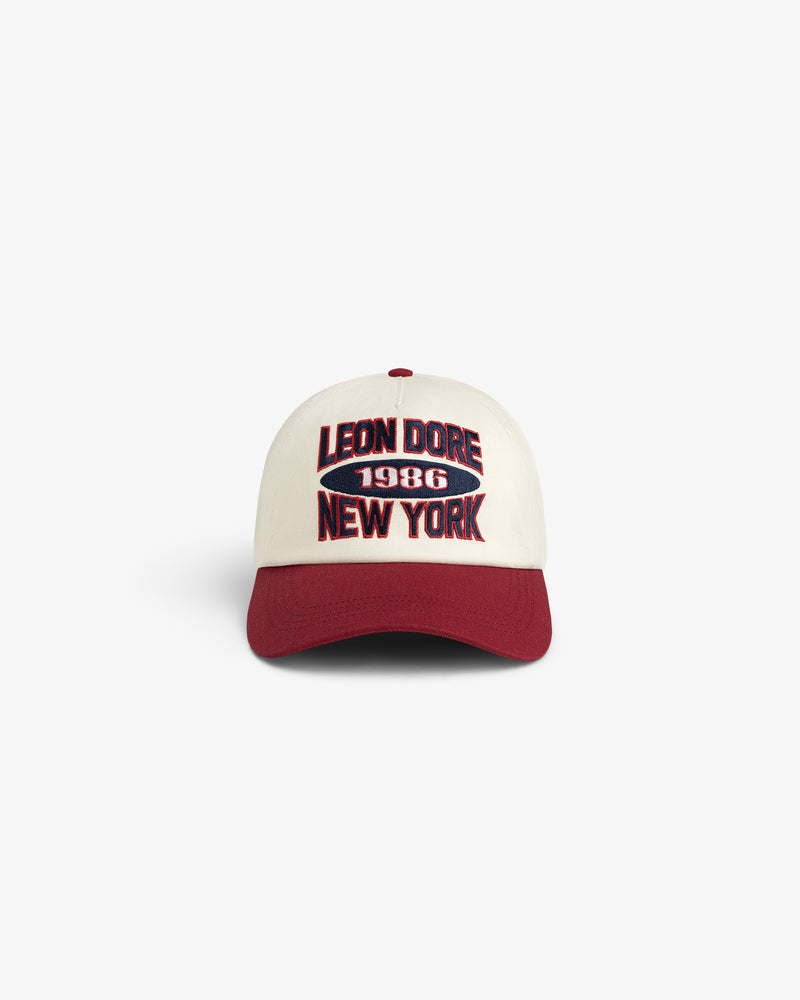 Colorblock Club Hat: cream cap, burgundy brim, LEON DORE 1986 NEW YORK embroidered on front.