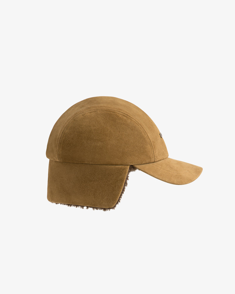 Tan suede Shearling Earflap Hat with down-turned earflaps and a fuzzy lining.