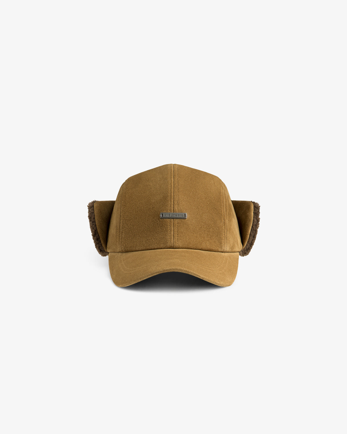 Tan suede Shearling Earflap Hat with fur-lined earflaps and a metal brand plate on the front.