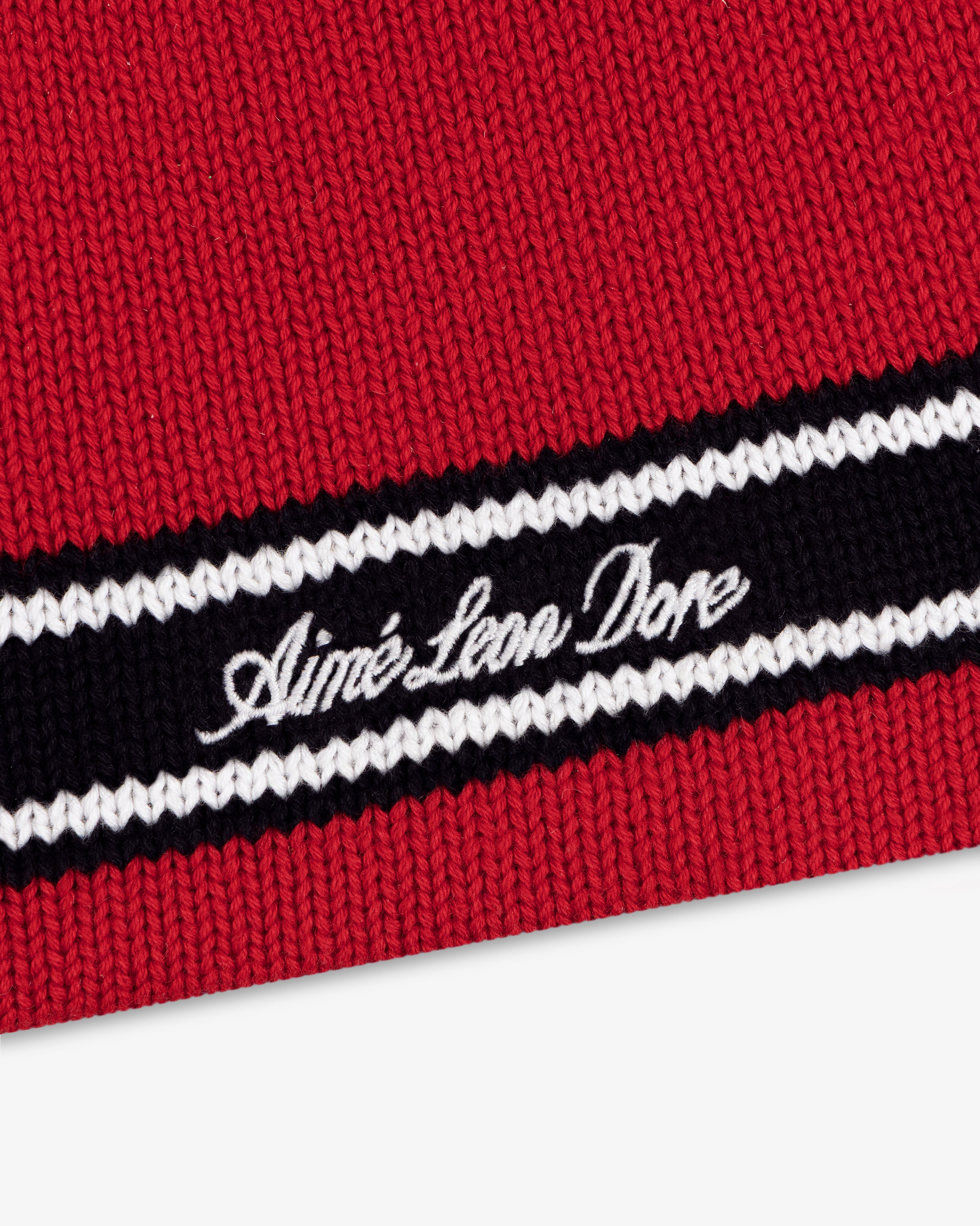 Red Stripe Knit Beanie with black and white stripes and Aimé Leon Dore cursive embroidery.