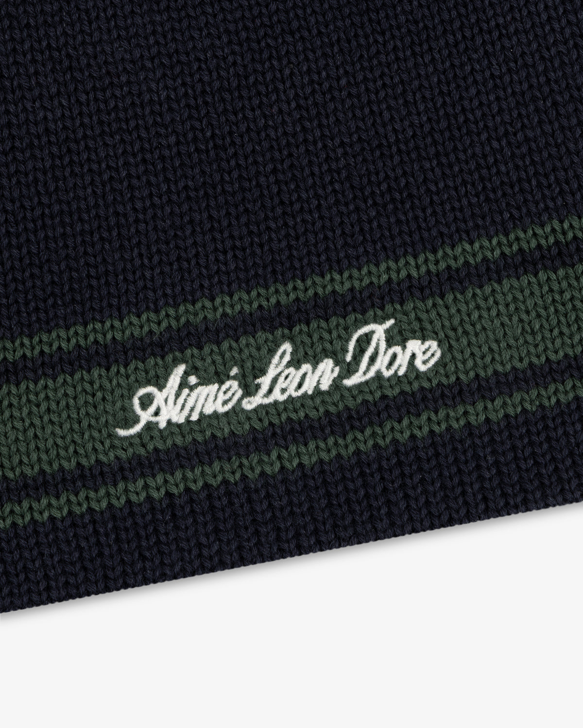 Navy Stripe Knit Beanie with green stripes and Aimé Leon Dore embroidered in white script.