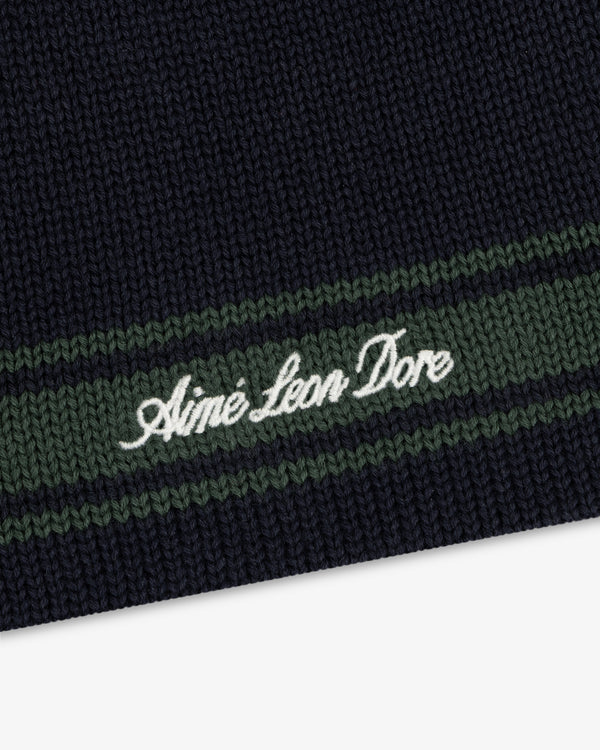Navy Stripe Knit Beanie with green stripes and Aimé Leon Dore embroidered in white script.