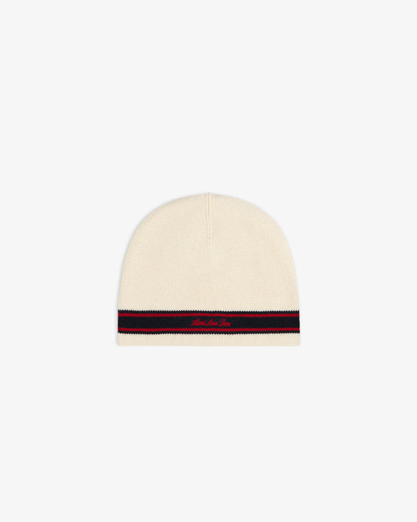 Stripe Knit Beanie: Cream knit with black and red stripe by hem, plus small red embroidered text.
