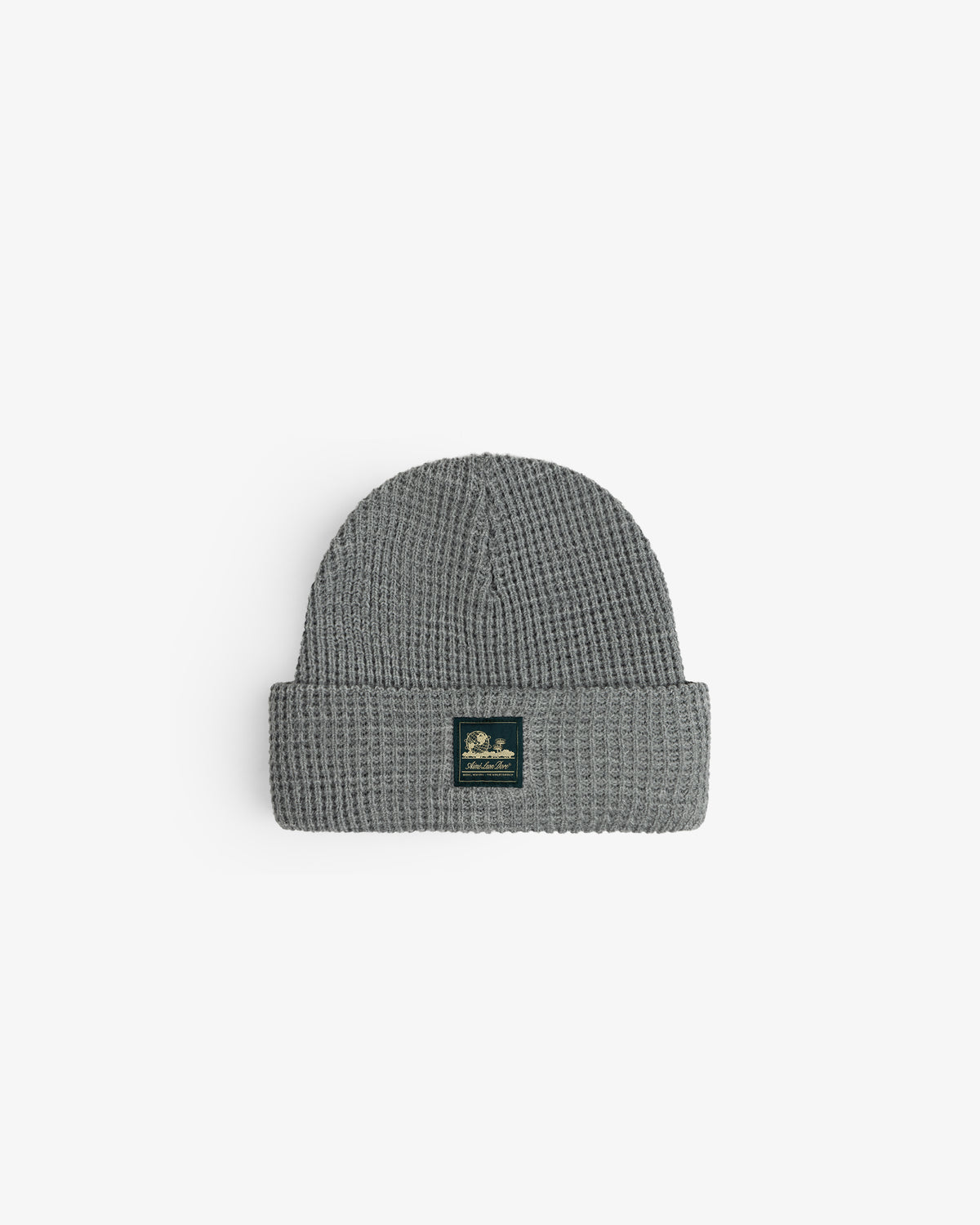 Waffle Knit Beanie in gray with folded brim and black front patch, displayed on a white background.